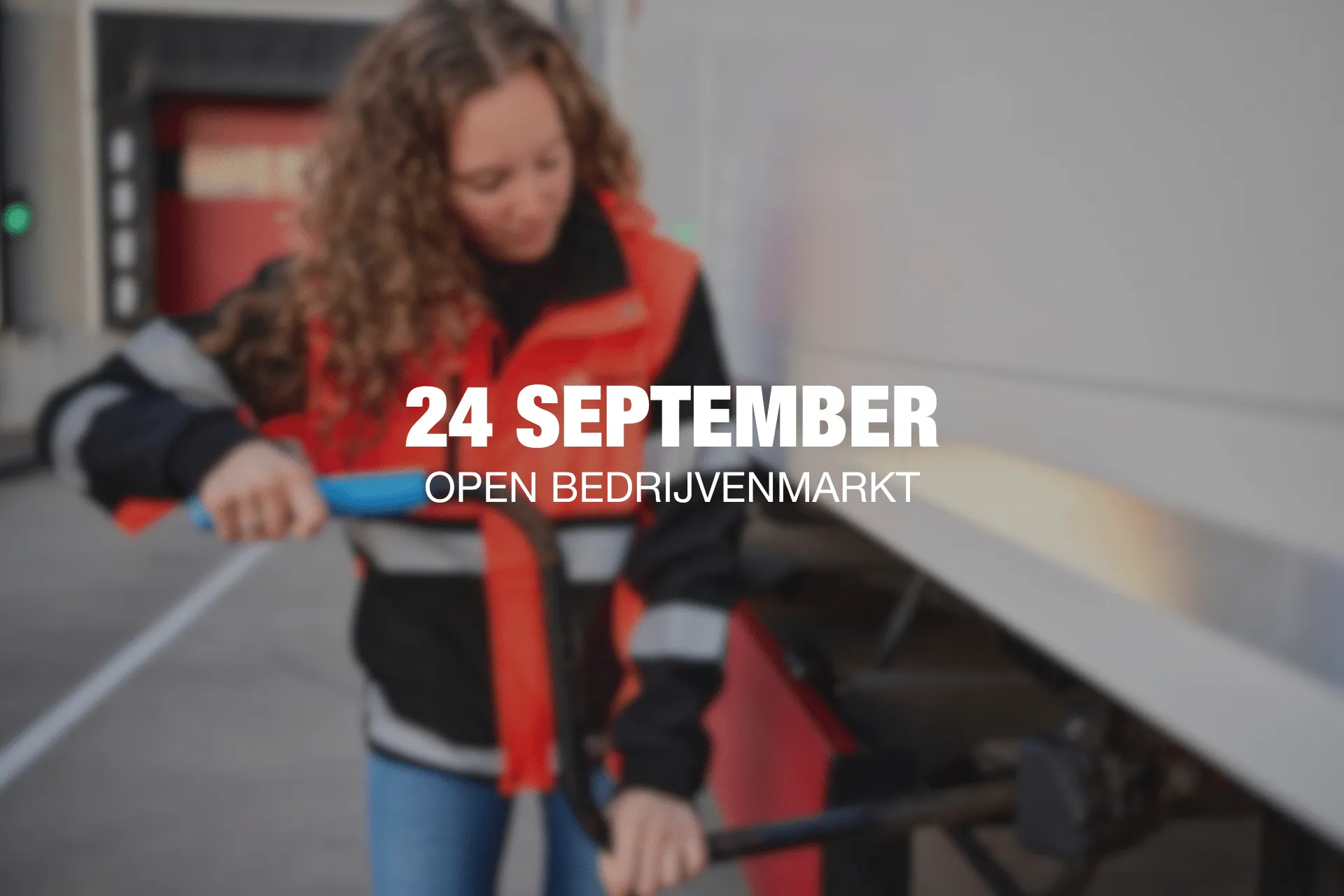 Promotional banner for '24 September Open Bedrijfmarkt' featuring a person in a red safety vest in a workshop setting (blurry).